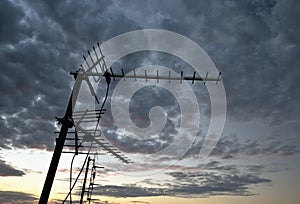 Aerial antenna on the roof with cloudy background