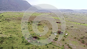 Aerial Approaching Drone Shot. Traditional Masai village at Sunset time near Arusha, Tanzania.