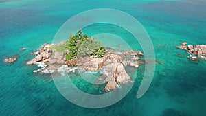 Aerial arc shot around granite uninhabited tiny islet Saint Pierre