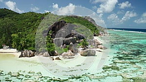 Aerial arc shot over a unique incomparable beach Anse Source d`Argent