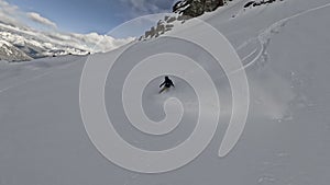 Aerial around view extreme man snowboard downhill freeride on snowy mountain