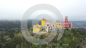 Aerial around view of Pena Palace Palacio da Pena in Sintra, Portugal. The palace is UNESCO World Heritage Site, shot from drone