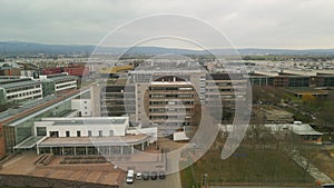 Aerial ascending footage of buildings in Campus Riedberg. Complex of Goethe University. Frankfurt am Main, Germany