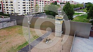 Aerial ascending footage of guard tower and area between border walls. Historic part in Berlin Wall Memorial. Berlin