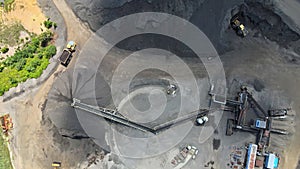 Aerial of asphalt and cement factory large piles of construction rocks used for asphalt production heavy machinery ready