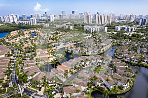 Aerial of Aventura Lakes, a high-end residential community, with skyline of Sunny Isles Beach in the distance