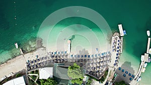 Aerial, Azure Beach with Empty Sun Loungers and Boats, Balkan Sea Coast, Albania