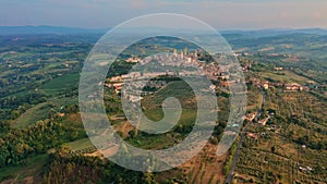 Aerial backward revealing wide shot of San Gimignano, Tuscany, Italy.