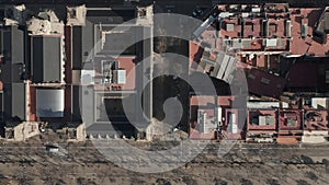 Aerial: Barcelona overhead drone shot of typical city blocks in beautiful sunlight with urban traffic