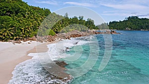 Aerial beach reveal footage on tropical coast at Anse Forbans. Mahe Island, Seychelles