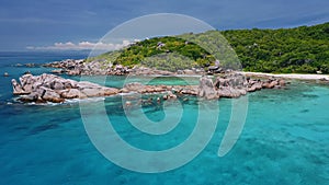 Aerial beach reveal footage on tropical coast at Anse Forbans. Mahe Island, Seychelles