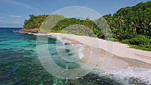 Aerial beach reveal footage on tropical coast at Anse Forbans. Mahe Island, Seychelles