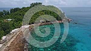 Aerial beach reveal footage on tropical coast at Anse Forbans. Mahe Island, Seychelles