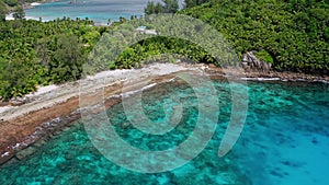 Aerial beach reveal footage on tropical coast at Anse Forbans. Mahe Island, Seychelles