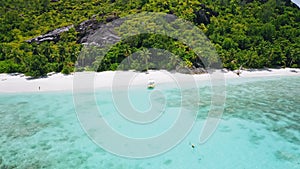 Aerial beach reveal footage on tropical coast at Anse Forbans. Mahe Island, Seychelles