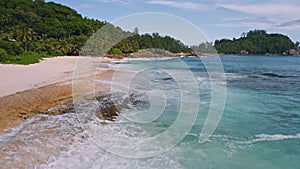 Aerial beach reveal footage on tropical coast at Anse Forbans. Mahe Island, Seychelles