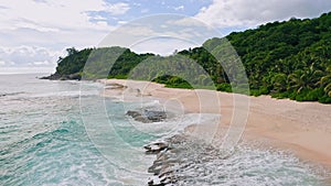 Aerial beach reveal footage on tropical coast at Anse Forbans. Mahe Island, Seychelles