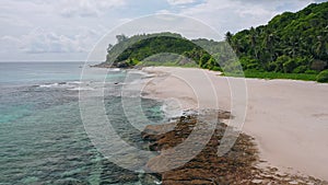 Aerial beach reveal footage on tropical coast at Anse Forbans. Mahe Island, Seychelles