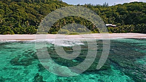 Aerial beach reveal footage on tropical coast at Anse Forbans. Mahe Island, Seychelles