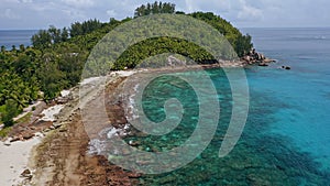 Aerial beach reveal footage on tropical coast at Anse Forbans. Mahe Island, Seychelles