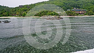 Aerial beach reveal footage on tropical coast at Anse Forbans. Mahe Island, Seychelles