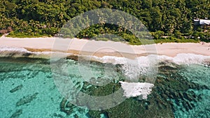 Aerial beach reveal footage on tropical coast at Anse Forbans. Mahe Island, Seychelles