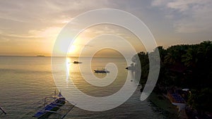 Aerial: Beautiful Beach Sunset With Wooden Boat In Moalboal, Cebu