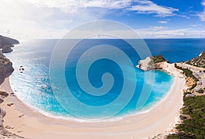 Aerial beautiful beach and water bay in the greek spectacular coast line. Turquoise blue transparent water, unique rocky cliffs,