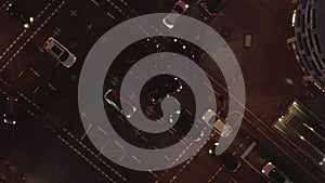 AERIAL: Beautiful Overhead Shot of busy intersection at night with Car traffic and city lights