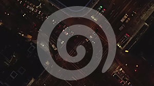 AERIAL: Beautiful Overhead Shot of busy intersection at night with Car traffic and city lights