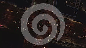 AERIAL: Beautiful Overhead Shot of busy intersection at night with Car traffic and city lights