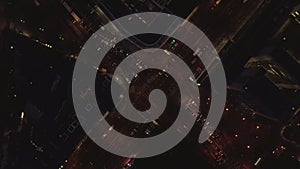 AERIAL: Beautiful Overhead Shot of busy intersection at night with Car traffic and city lights