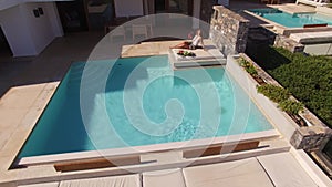 Aerial: Beautiful Young Woman Enjoying In Ocean Front Villa Pool