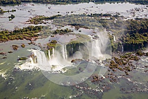 Aerial bird`s-eye view of beautiful rainbow above Iguazu Falls Devil`s Throat chasm from a helicopter flight. Brazil and Argentina