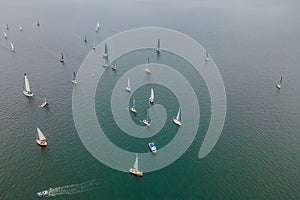 Aerial bird's eye view photo taken by drone of sailboat in turquoise sea water