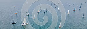 Aerial bird's eye view photo taken by drone of sailboat in turquoise sea water BANNER, LONG FORMAT