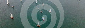 Aerial bird's eye view photo taken by drone of sailboat in turquoise sea water BANNER, LONG FORMAT