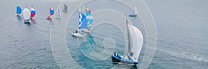 Aerial bird's eye view photo taken by drone of sailboat in turquoise sea water BANNER, LONG FORMAT