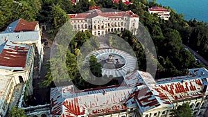 Aerial bird view footage of abandoned old mansion showing the building itself and the large abandoned fountain