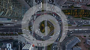Aerial birds eye overhead top down panning view of cars stuck in traffic jam. Multilane road around large and complex