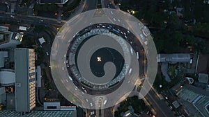 Aerial Birds Eye Overhead Top Down static View of vehicles driving around a busy Selamat Datang Monument roundabout at
