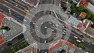 Aerial birds eye overhead top down view of cars driving through intersection on Rosenthaler Platz. Traffic in city