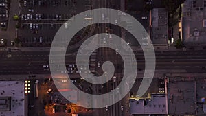 Aerial: birds eye view of Culver City, Los Angeles, California traffic, intersection at dusk with car traffic passing