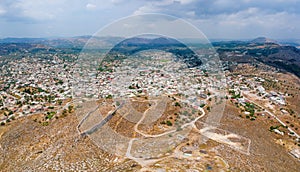 Aerial birds eye view drone photo ancient Archangelos scenic old town with castle on Rhodes island, Dodecanese, Greece. Beautiful