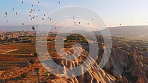 Aerial birds eye view tourist on viewpoint watch hot air balloons in sky on sunrise in cappadocia