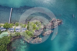 Aerial birds eye view of tropical out crop with ocean and hotel