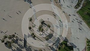 AERIAL birds view flight over Venice Beach skatepark with palm trees and beatiful shadows, Sunny, Los Angeles California