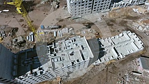 Aerial of builders working on top of building on construction site