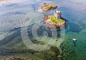 Aerial canoes gathering around the historic castle Stalker in Argyll