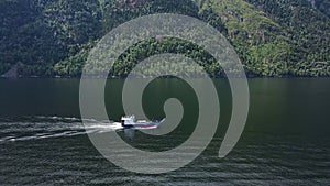 Aerial: A cargo barge on the Teletskoye Lake in the middle of the mountains